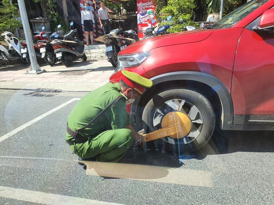 Công an Nha Trang khoá bánh xe ôtô vi phạm. Ảnh: CT Kim