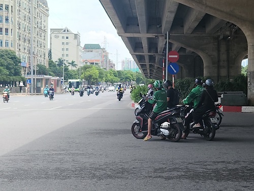 Lái xe ôm công nghệ vi vượt đèn đỏ tại ngã tư Phạm Hùng - Mễ Trì - Dương Đình Nghệ. Ảnh: Minh Hạnh chụp 12 giờ ngày 25.7.2024